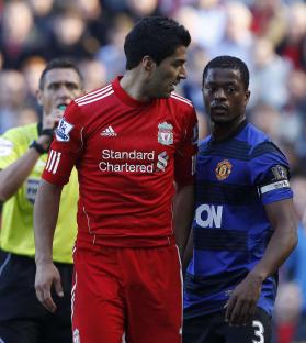 Luis SuÃ¡rez and Patrice Evra during a soccer match.