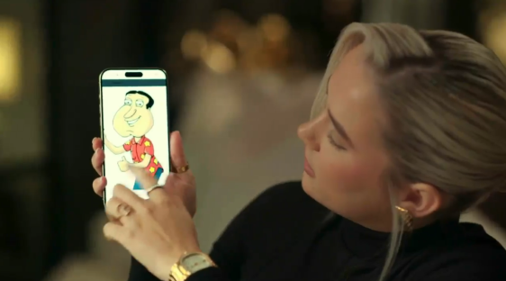 Woman looking at a phone displaying a cartoon image of Quagmire from Family Guy.