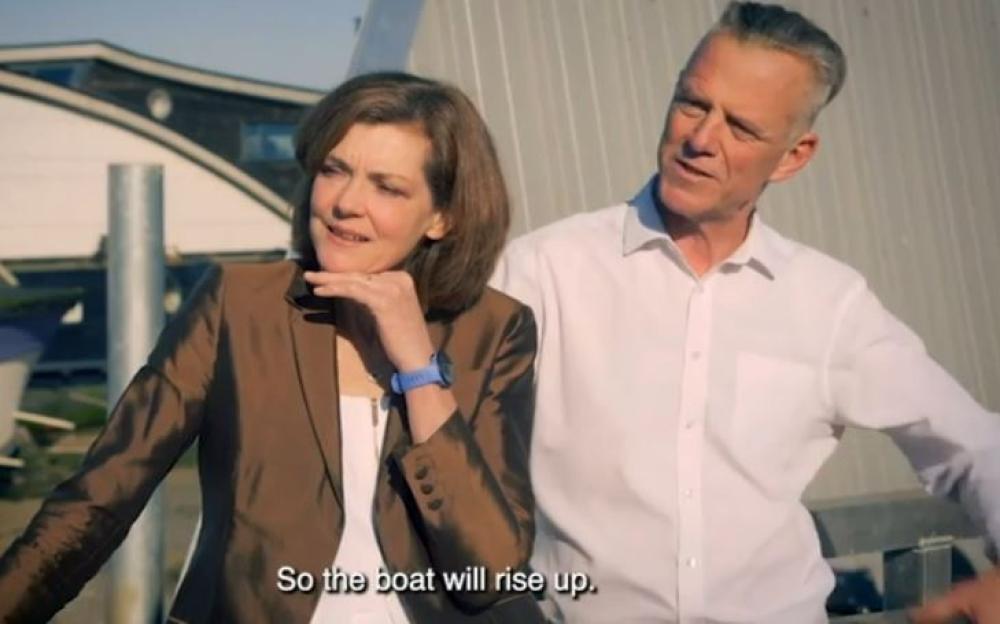Screenshot of a man and woman from Grand Designs, captioned "So the boat will rise up."