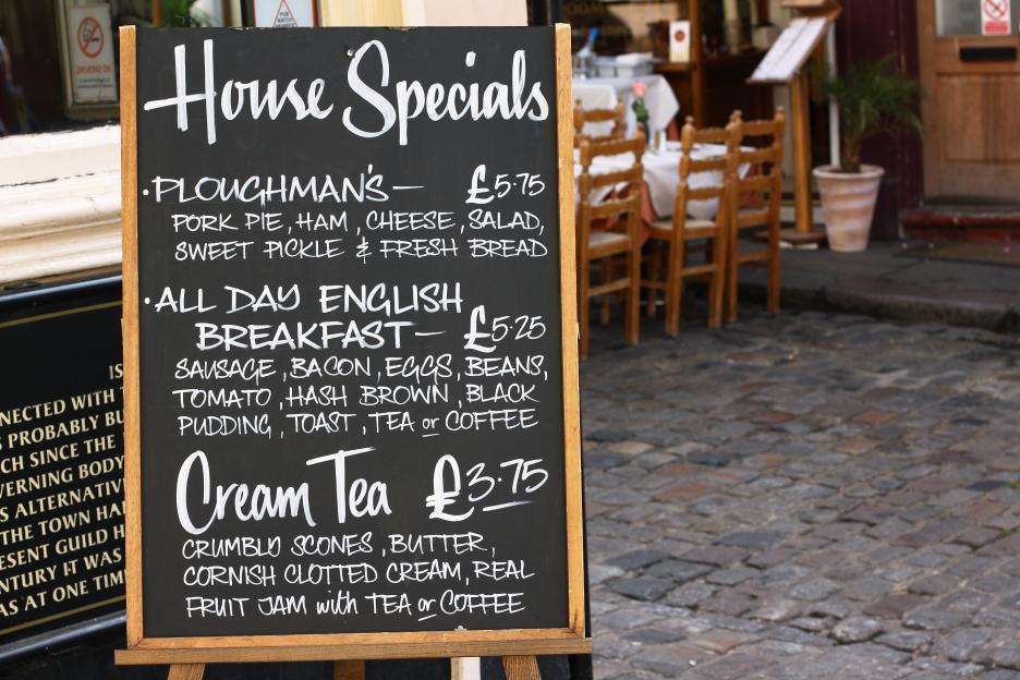 Chalkboard menu listing house specials: Ploughman's, English breakfast, and cream tea.