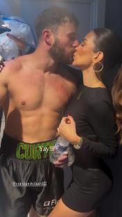Ekin-Su kissing Curtis Pritchard backstage at a boxing match.