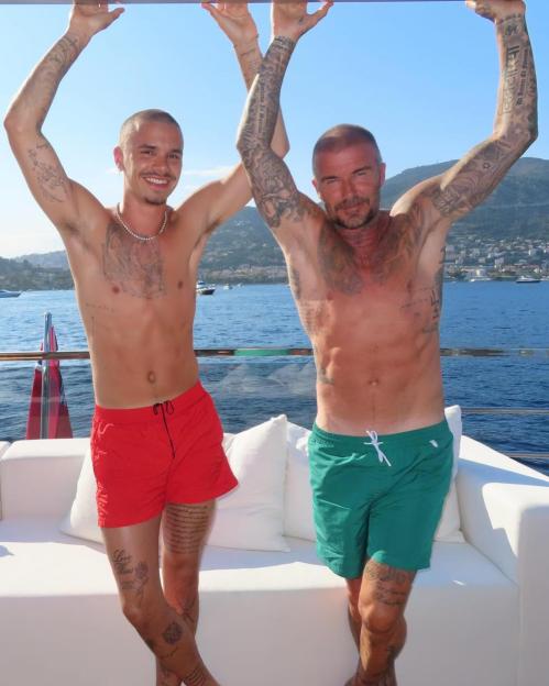 David and Romeo Beckham on a boat.
