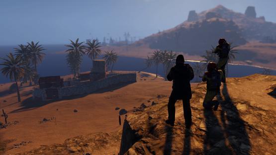 Soldiers overlooking a desert outpost.