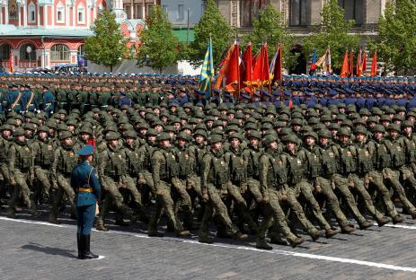 Russian soldiers marching in formation during a military parade.