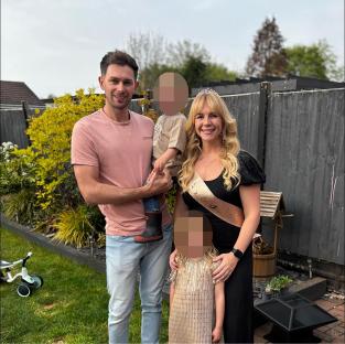 Family photo of a man and woman with their two young children.
