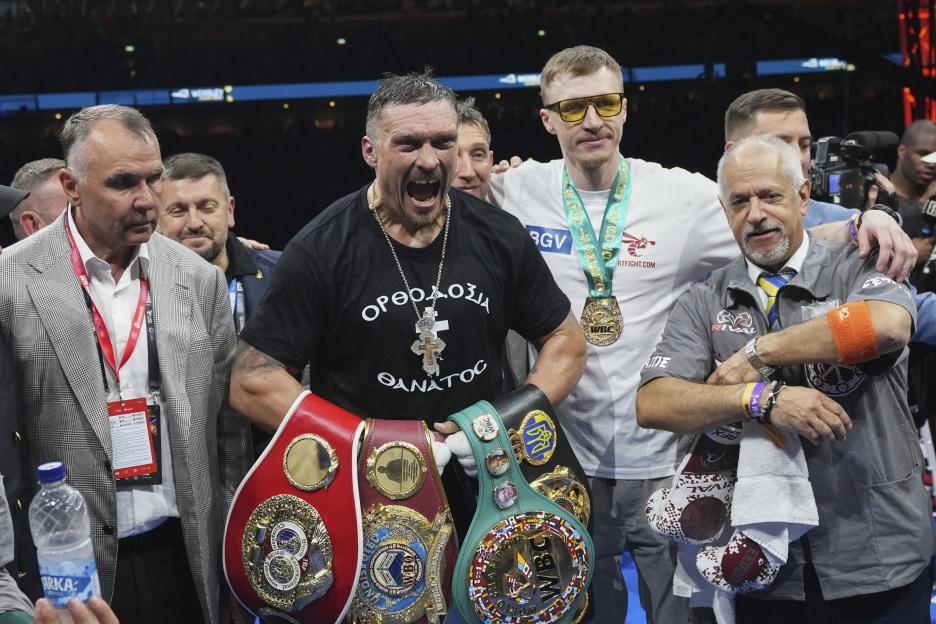 Oleksandr Usyk celebrates his undisputed world heavyweight boxing title win.
