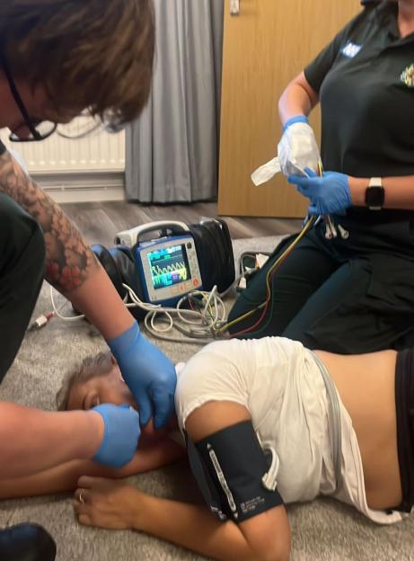 Paramedics providing emergency medical care to a patient.