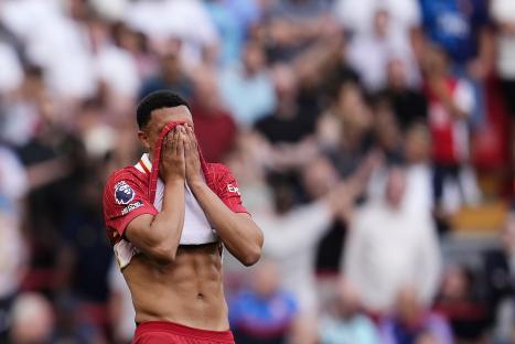 Trent Alexander-Arnold looking dejected during a soccer match.