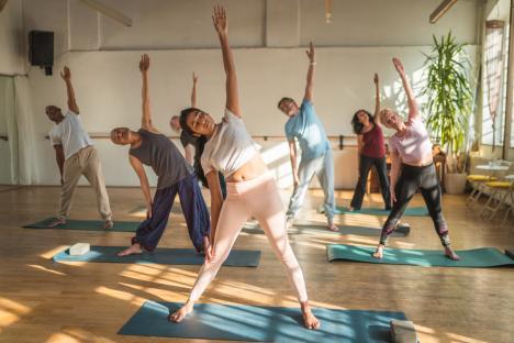 Diverse group of seniors participating in a yoga class.