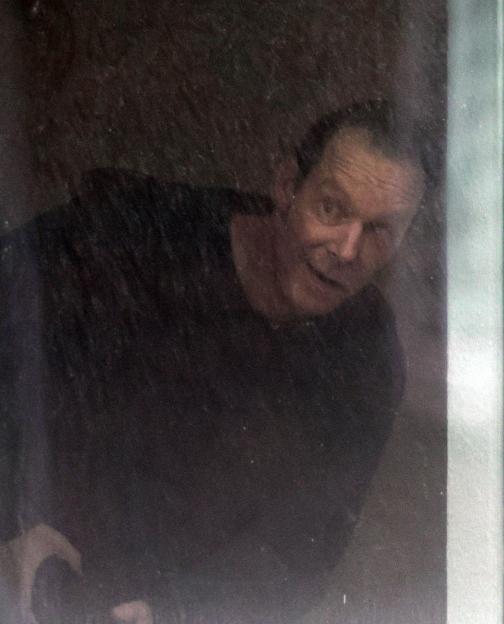 Christian Brueckner looking out of a window.