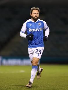 Bradley Dack of Gillingham F.C. running on the soccer field.