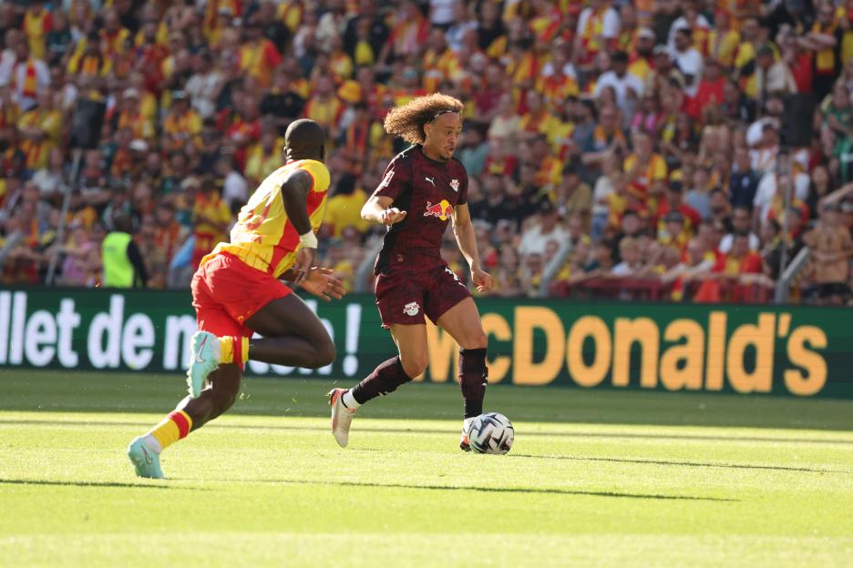 Xavi Simons of RB Leipzig dribbling the soccer ball during a match.