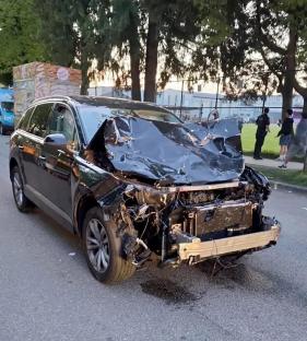 Severely damaged black SUV.