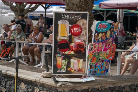 Tenerife restaurant menu boards showing beer, sangria, cocktails, ice cream, and other treats.