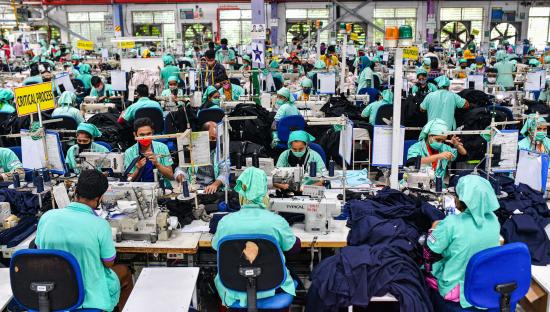 Garment workers sewing in a Bangladeshi factory.