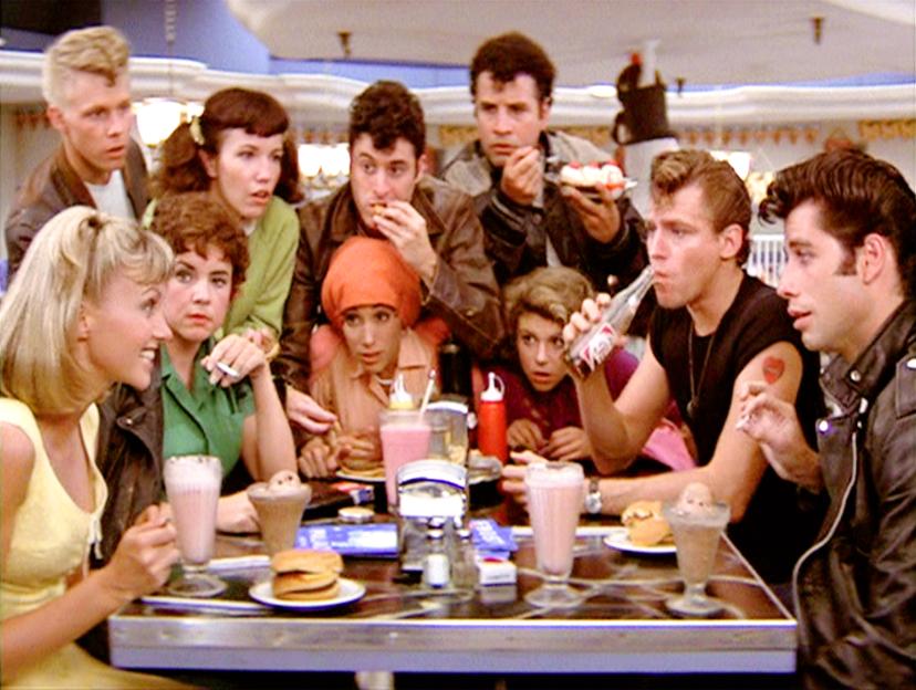 The cast of "Grease" at a malt shop.