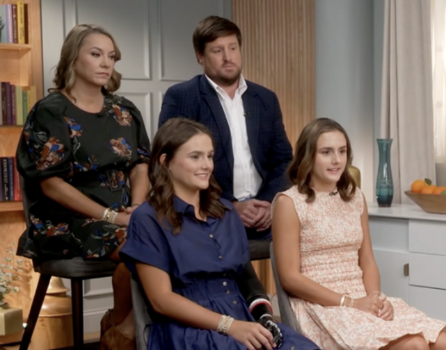 Lulu Gribbin with her family on Good Morning America, showing her prosthetic arm.