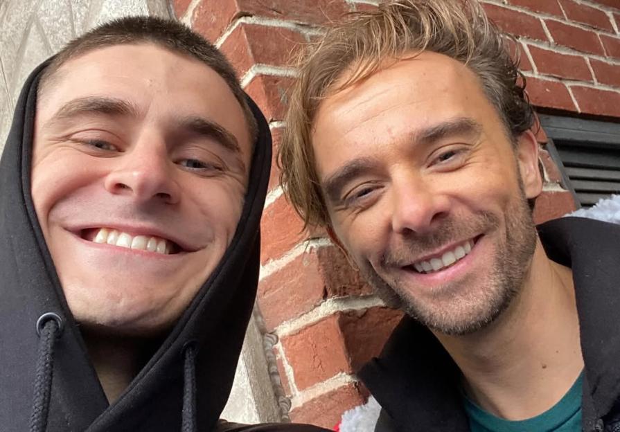 Two men smiling for a selfie.