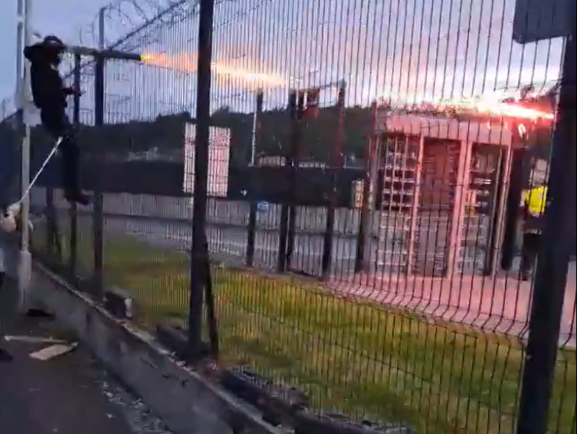 Horrifying moment rival football yobs blast FIREWORKS & batter each other with sticks in huge brawl before game