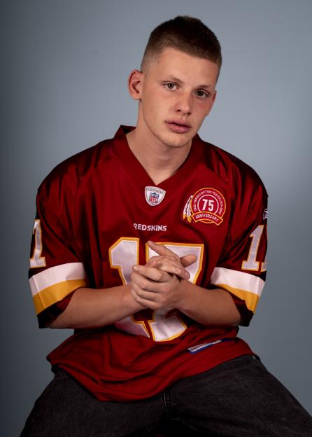 Portrait of a young man wearing a Washington Redskins jersey.