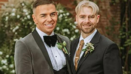 Two men in suits at their wedding.