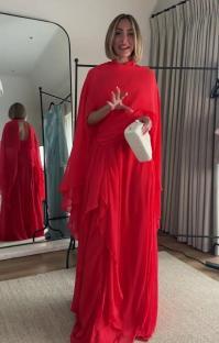 Frankie Bridge in a red gown and cape.