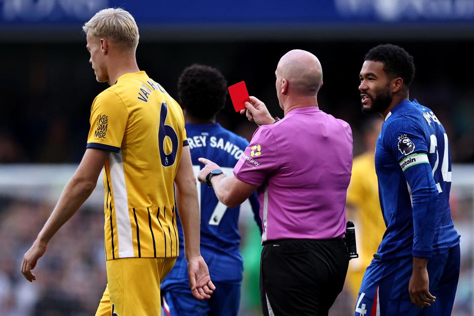 Reece James talks to Referee Simon Hooper as he shows a red card to a player.