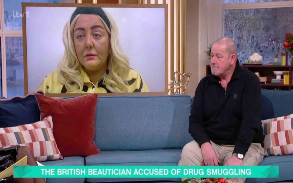 A man sits on a teal couch next to a television screen showing a woman; the caption reads, "The British beautician accused of drug smuggling."