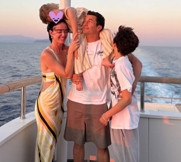 Katy Perry and Orlando Bloom with their children on a boat.
