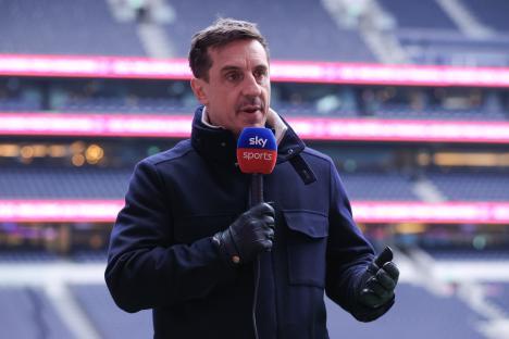 Gary Neville, Sky Sports pundit, speaking into a microphone at a soccer match.