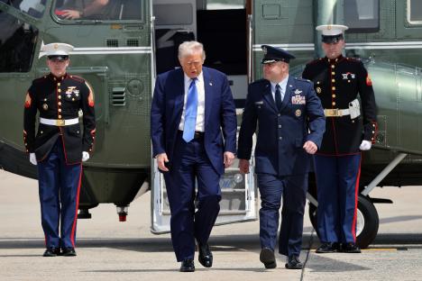 President Trump walking with a military officer at Joint Base Andrews.