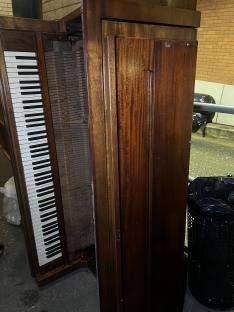 A discarded upright piano.