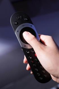 Hand holding Sky Q remote.
