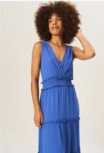 Woman in a blue tiered maxi dress.