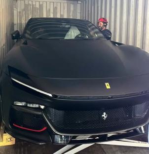 Black Ferrari Purosangue in a shipping container.