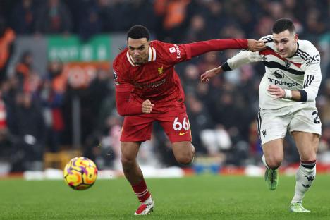 Liverpool's Trent Alexander-Arnold vying with Manchester United's Diogo Dalot during a Premier League match.