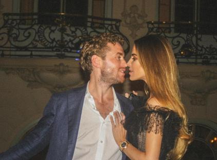 A man and woman facing each other, about to kiss.
