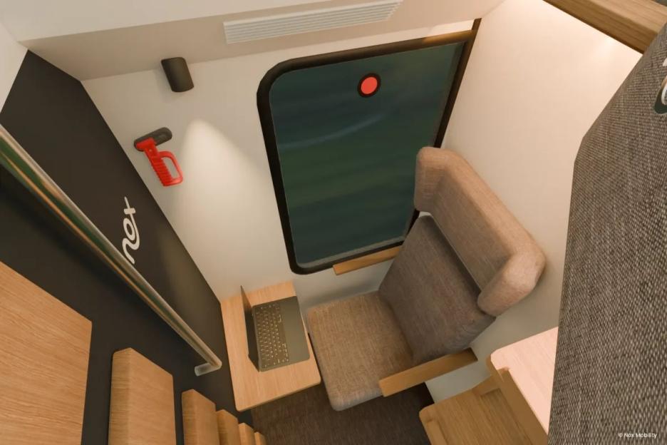 Illustration of a private train room with a seat, small table, and laptop.