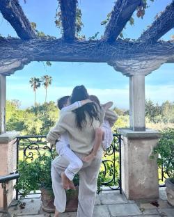 Meghan Markle holding her two children.