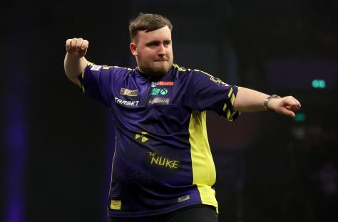 Luke Littler reacting during a darts match.