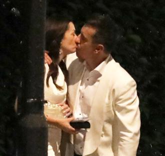 Gary Neville and his wife kissing at a party.