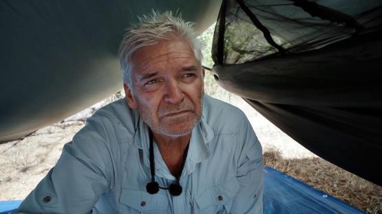 Phillip Schofield in a hammock on a beach.