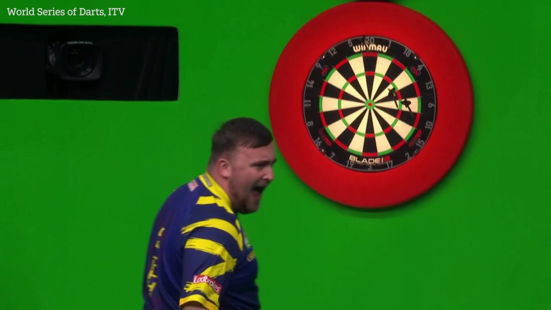 Luke Littler reacts angrily during a darts match.