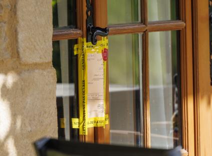 Crime scene notice taped to a door.