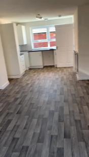 Interior view of a council house kitchen and living area.