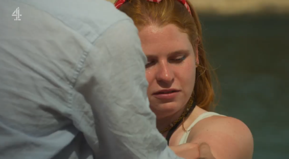 Charlotte and Jason having an awkward encounter on a beach.