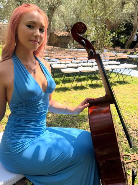 Young woman in blue dress with cello.
