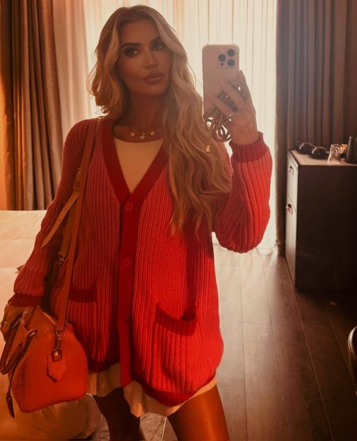 Selfie of Christine McGuinness wearing a pink cardigan and minidress.