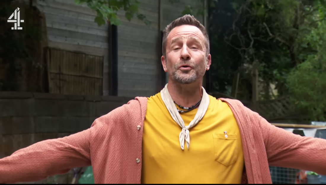Screenshot of a man speaking outdoors.