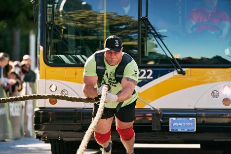 Mitchell Hooper pulling a bus in the World's Strongest Man competition.